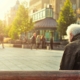 an elderly man sitting on a bench
